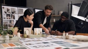 Agency producer, director, and cinematographer planning unbranded commercial shots with props, lighting, and storyboard frames